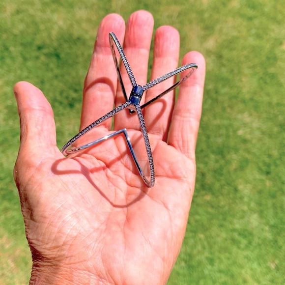 A beautiful silver bracelet with crystals on the outside of the bracelet. - Picture 6 of 8